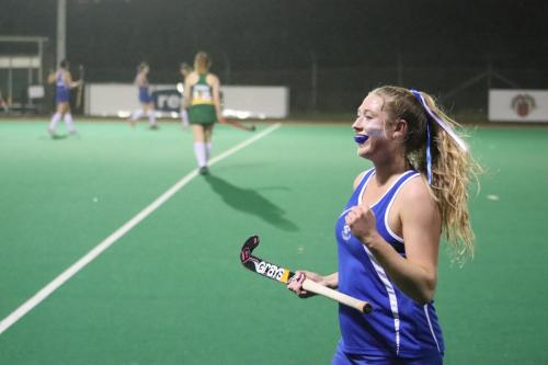 A hockey player celebrates on the field