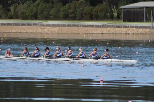 A team of athletes compete in the rowing event